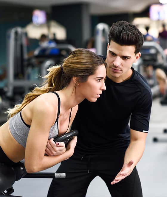 Coach assisting an athlete with performance training